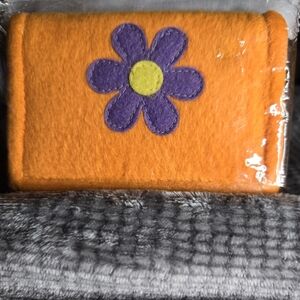 Colorful Flower Wallet 10 1/4" x 4 1/4" wide. Color:Orange, purple, and yellow.